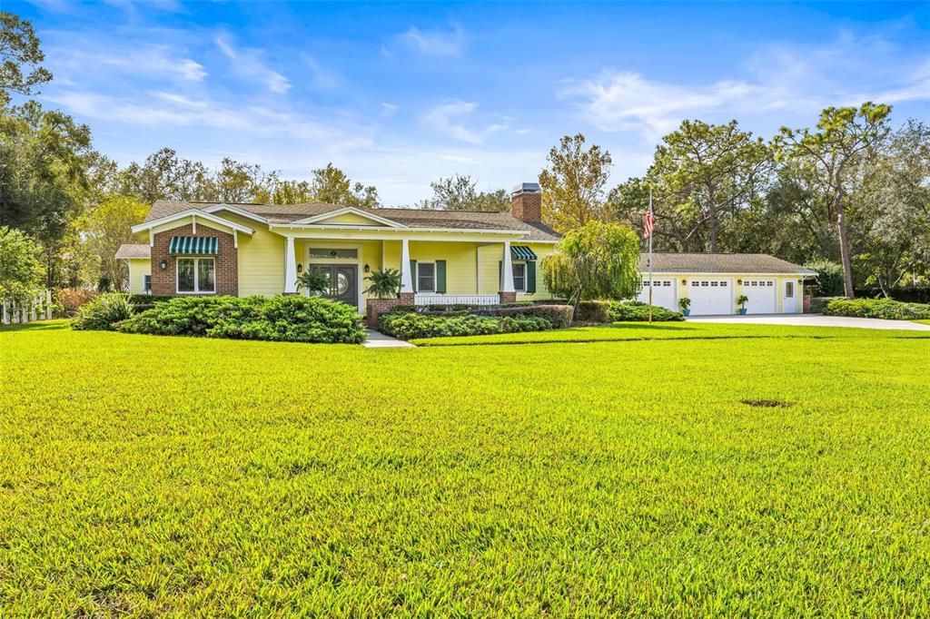 a front view of house with yard and green space