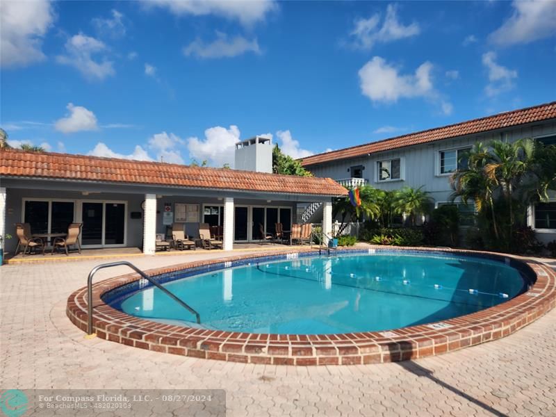 a view of a house with swimming pool and sitting area