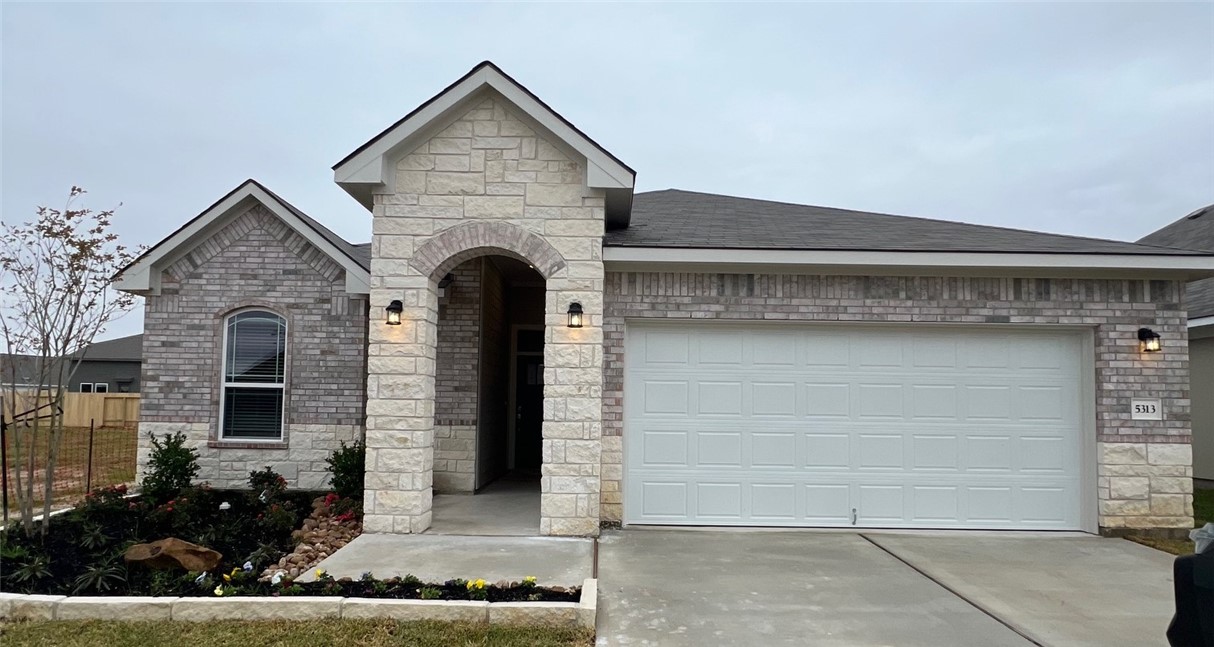 a front view of a house with garage