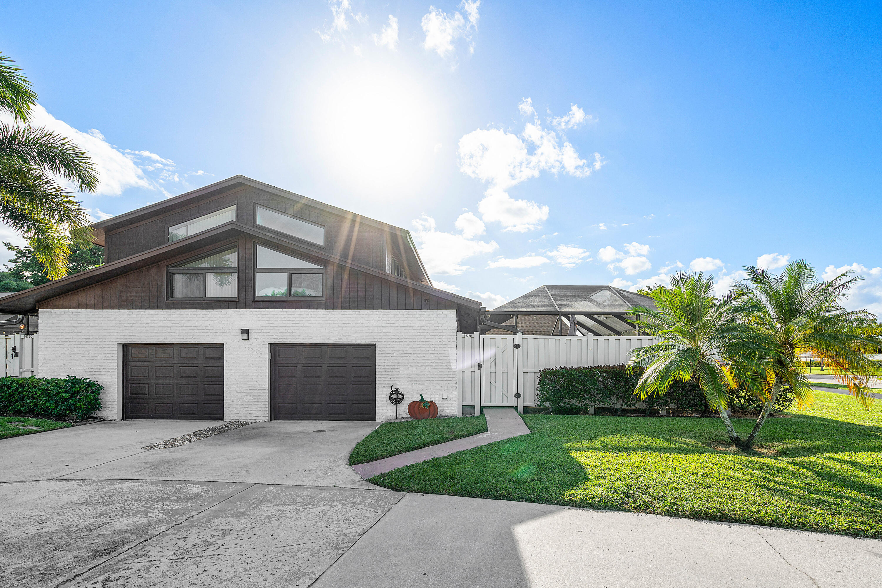 a front view of a house with a yard and a garage