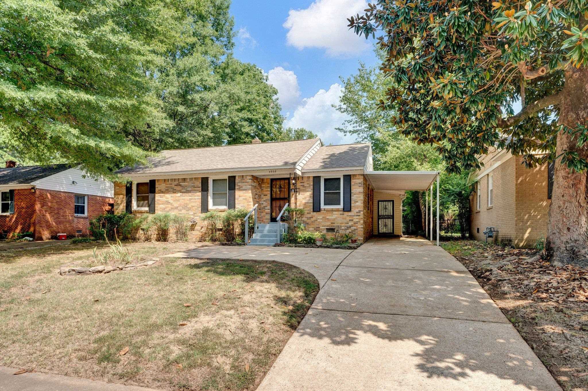 Ranch-style house with a carport and a front yard