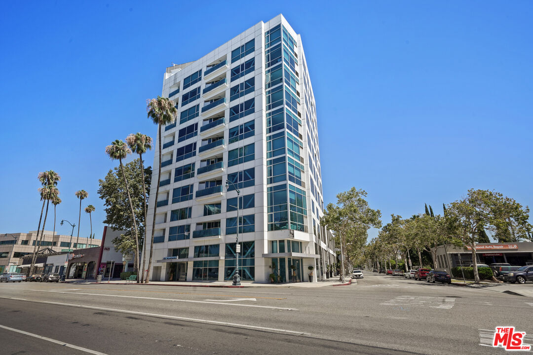 a view of a tall building next to a road