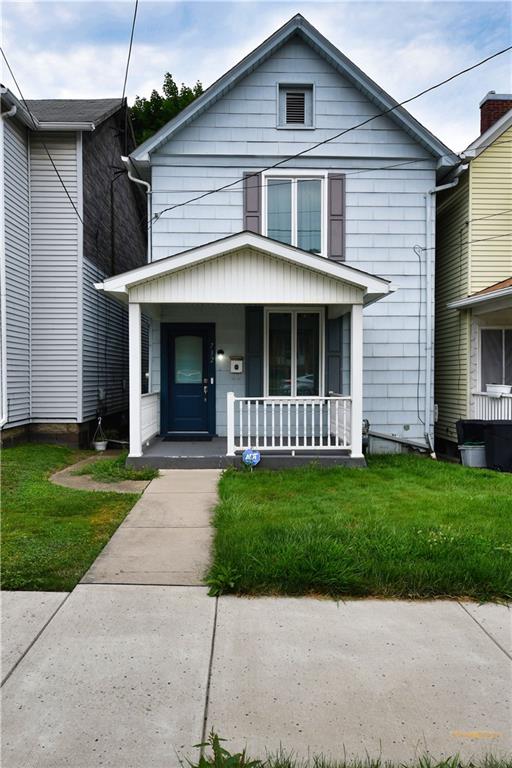 a view of a yard in front view of a house