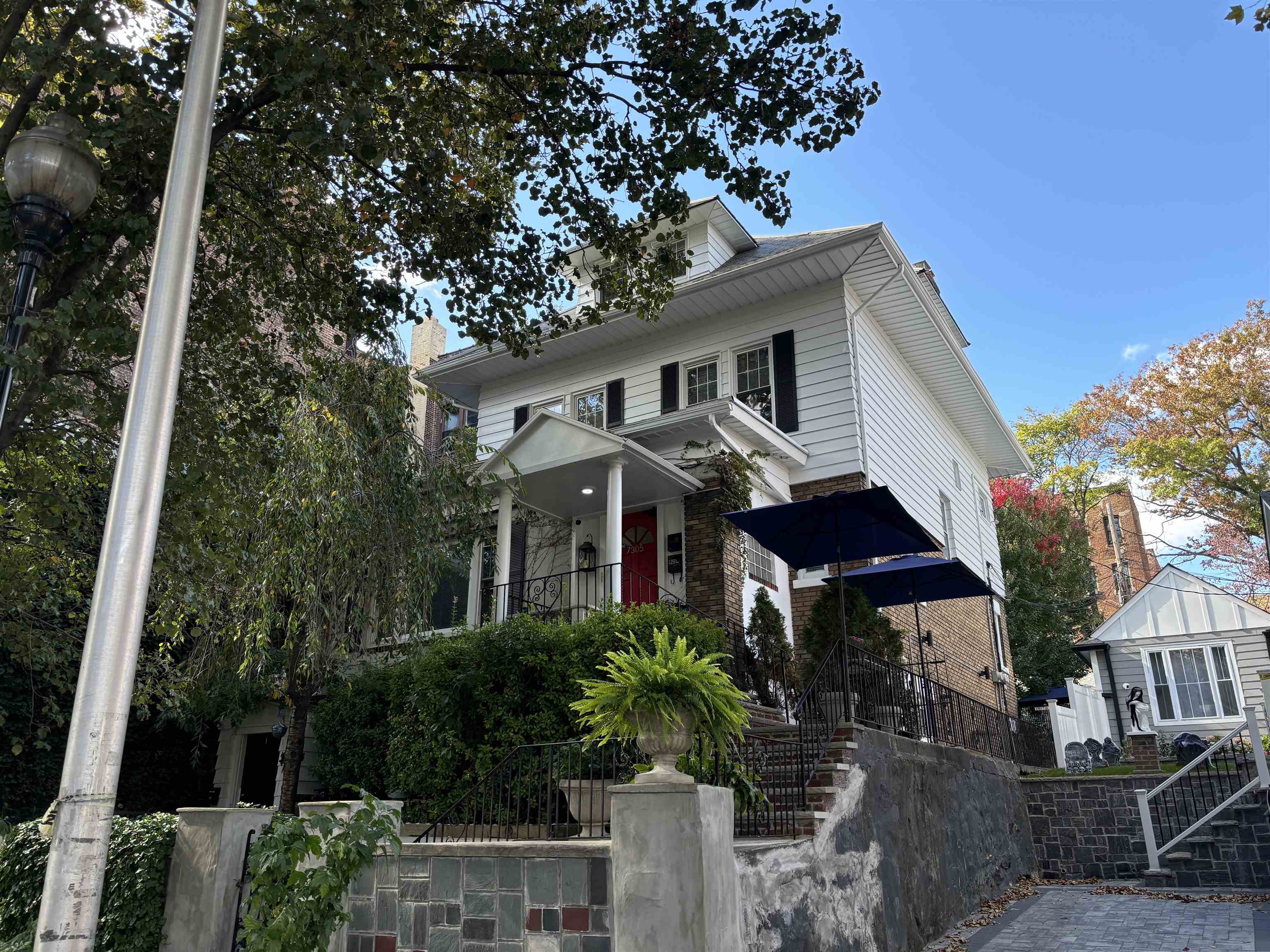 a front view of a house with a garden