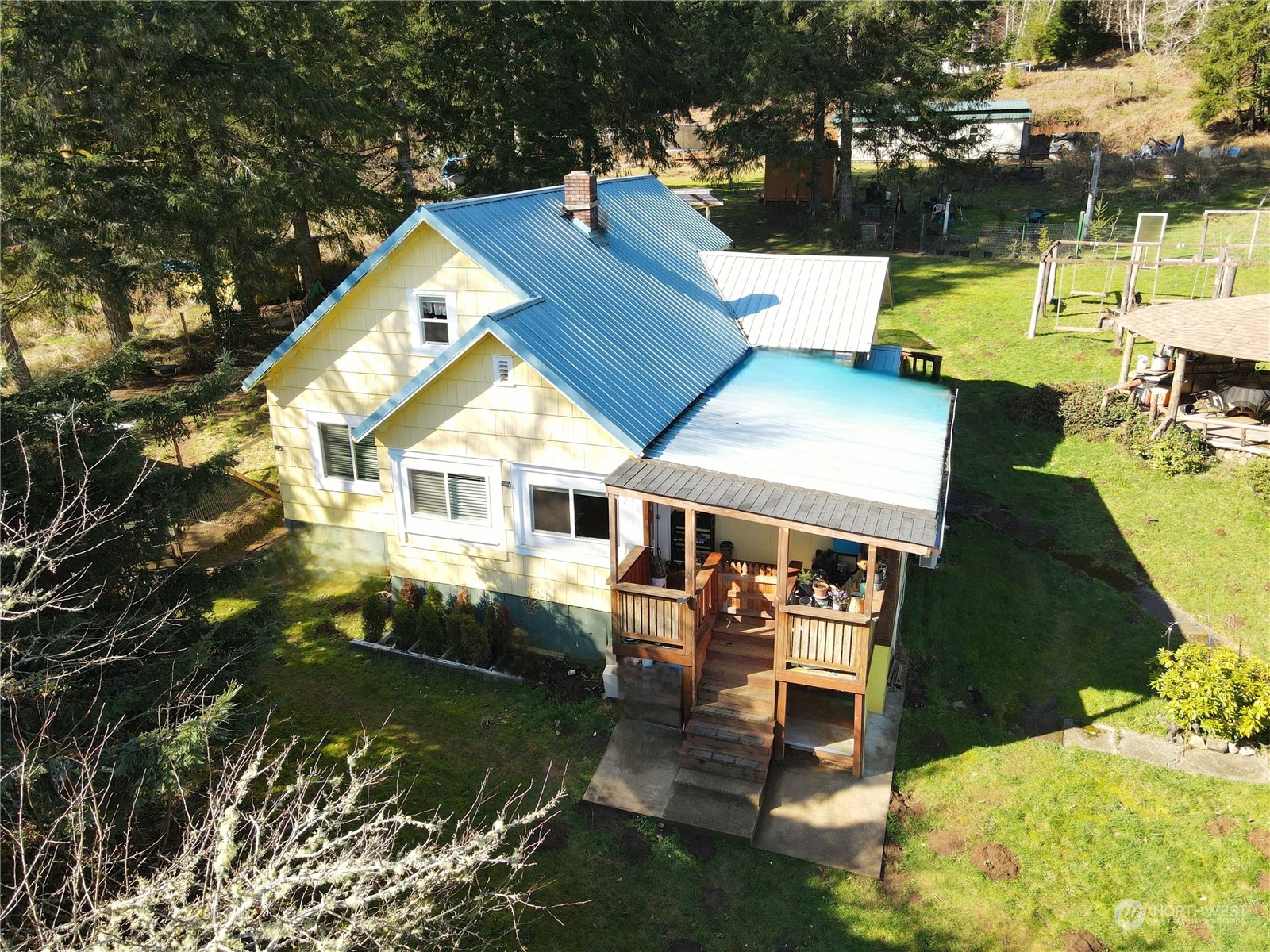 an aerial view of a house with swimming pool garden and patio