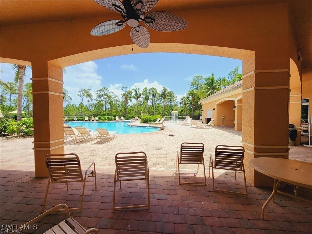 a view of a patio with table and chairs with wooden floor and fence