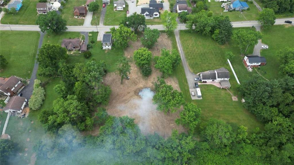 an aerial view of lake residential house with outdoor space and trees all around