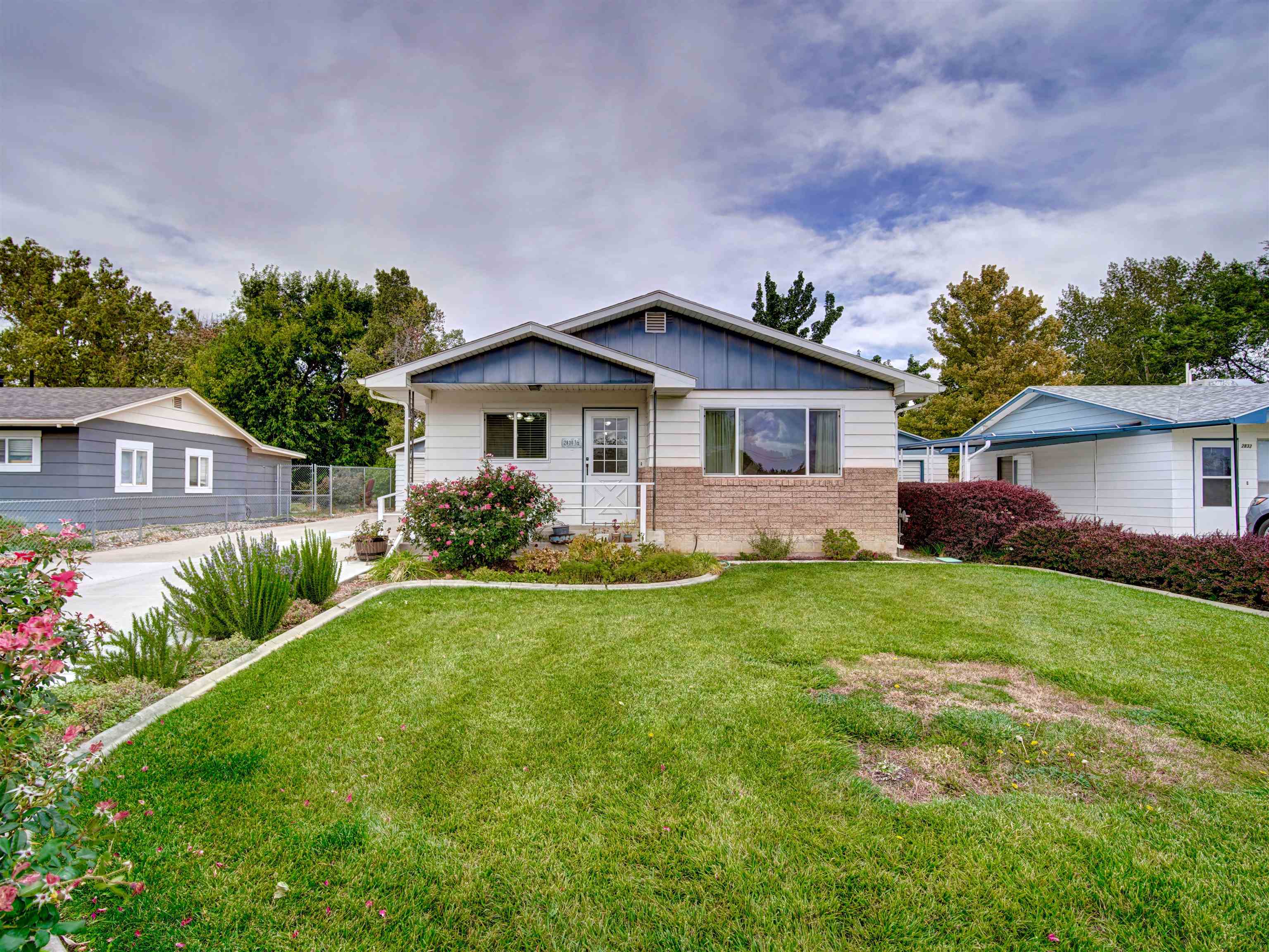 a front view of house with yard and green space