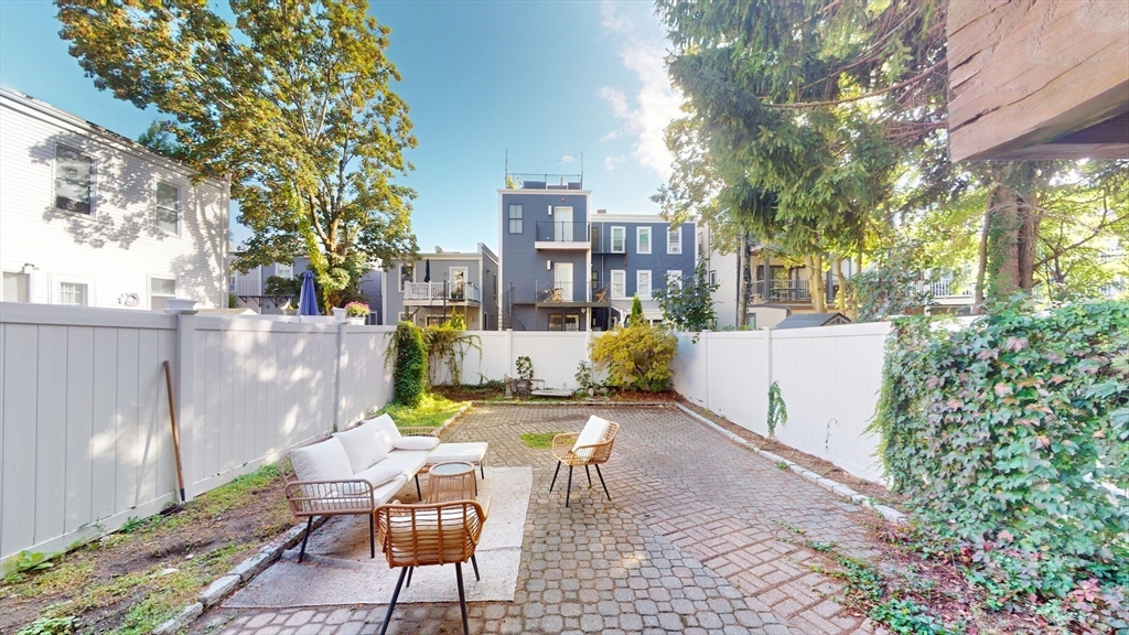 a view of a patio with table and chairs and potted plants