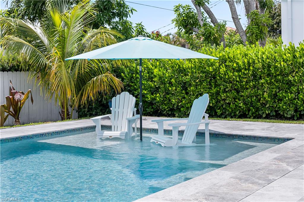 swimming pool view with a seating space