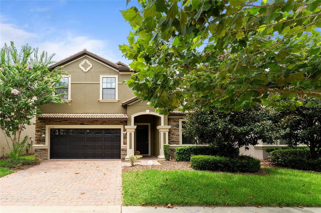 a front view of a house with a yard and garage