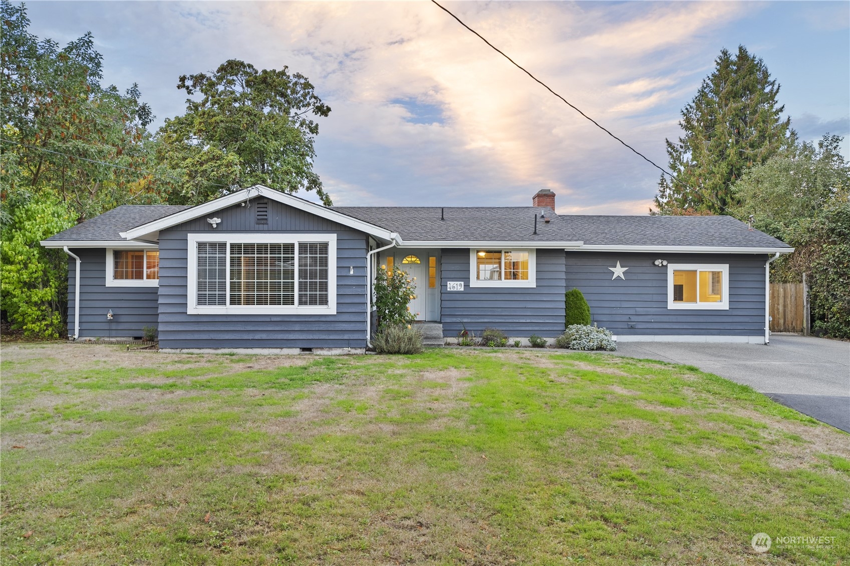 a front view of a house with a garden