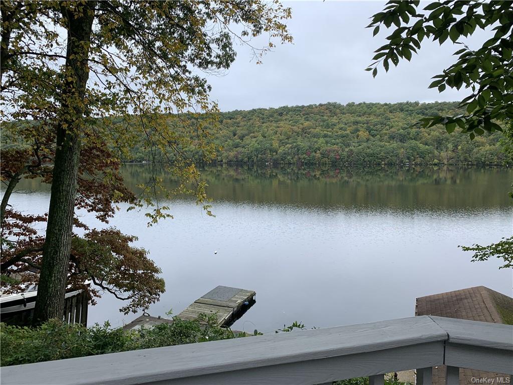 an aerial view of house with yard and lake view