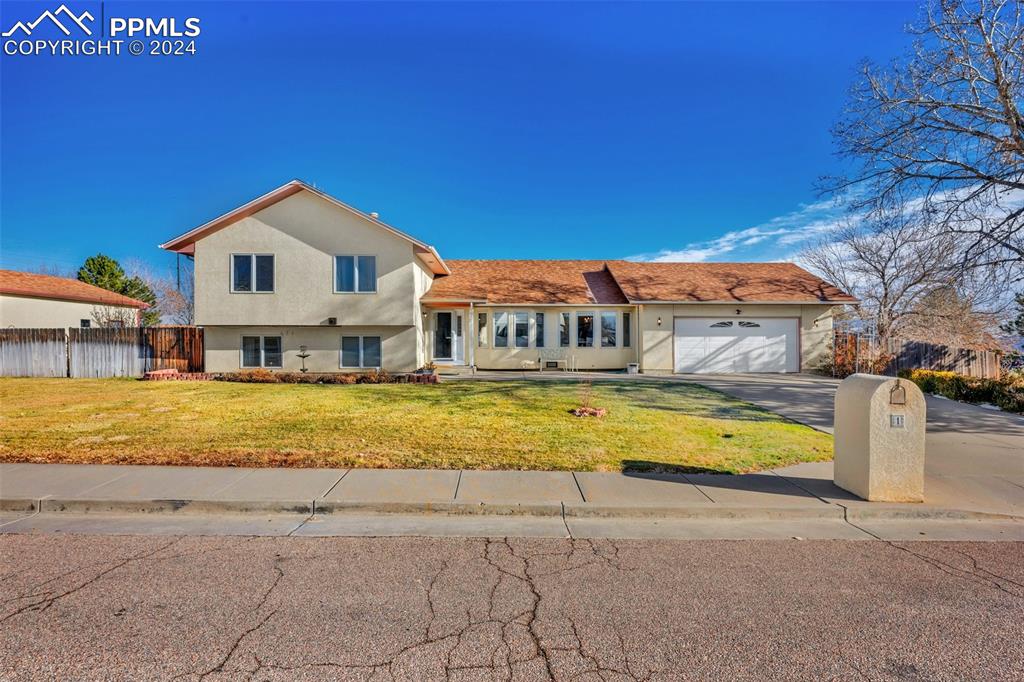 Front of home with an attached and detached 2 car garage