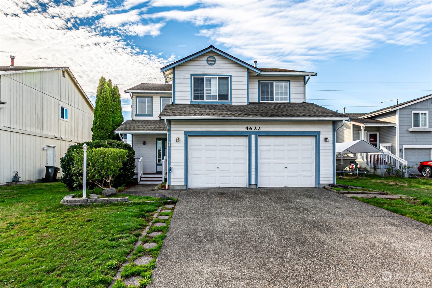 a front view of a house with a yard and garage