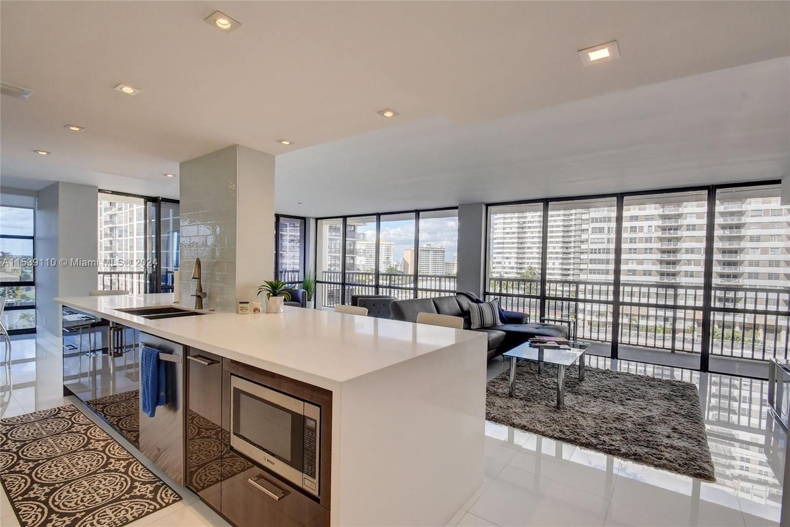 a large kitchen with kitchen island a large window in it