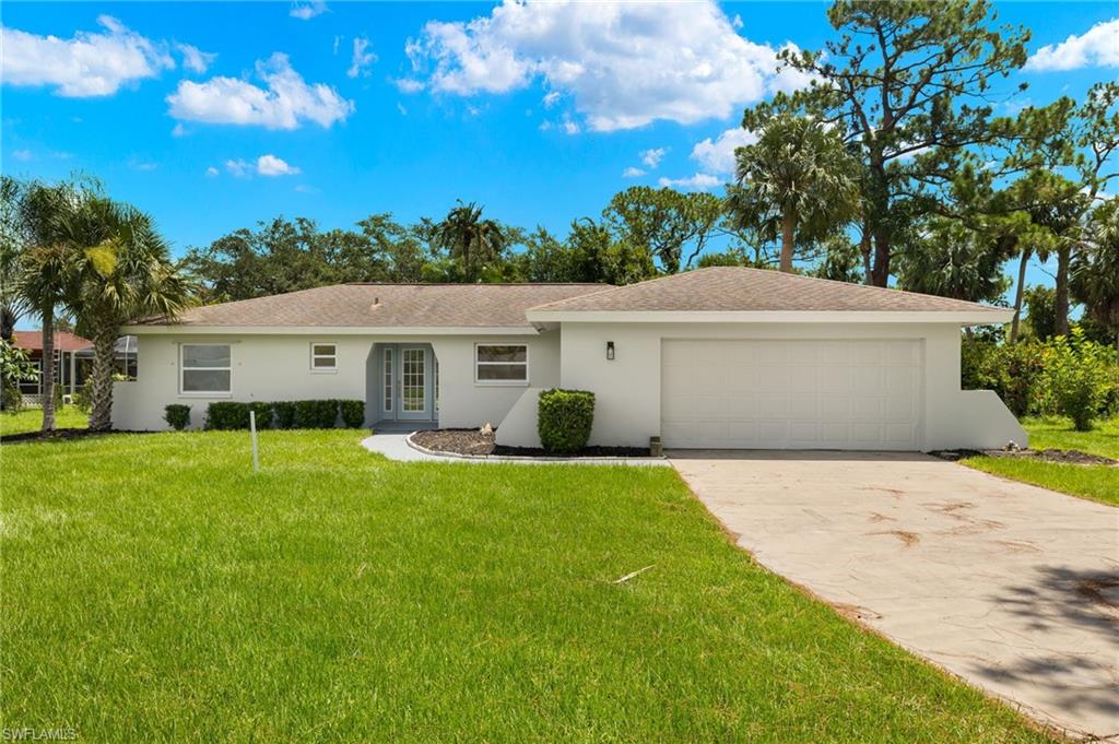 a view of a house with a backyard