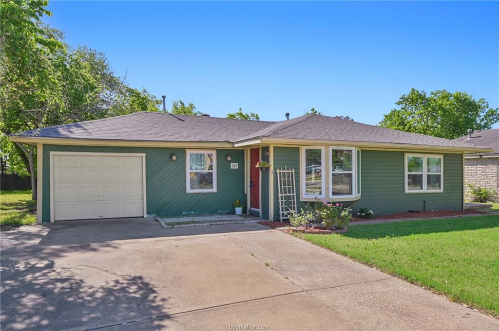 Ranch-style house with a front lawn and a garage