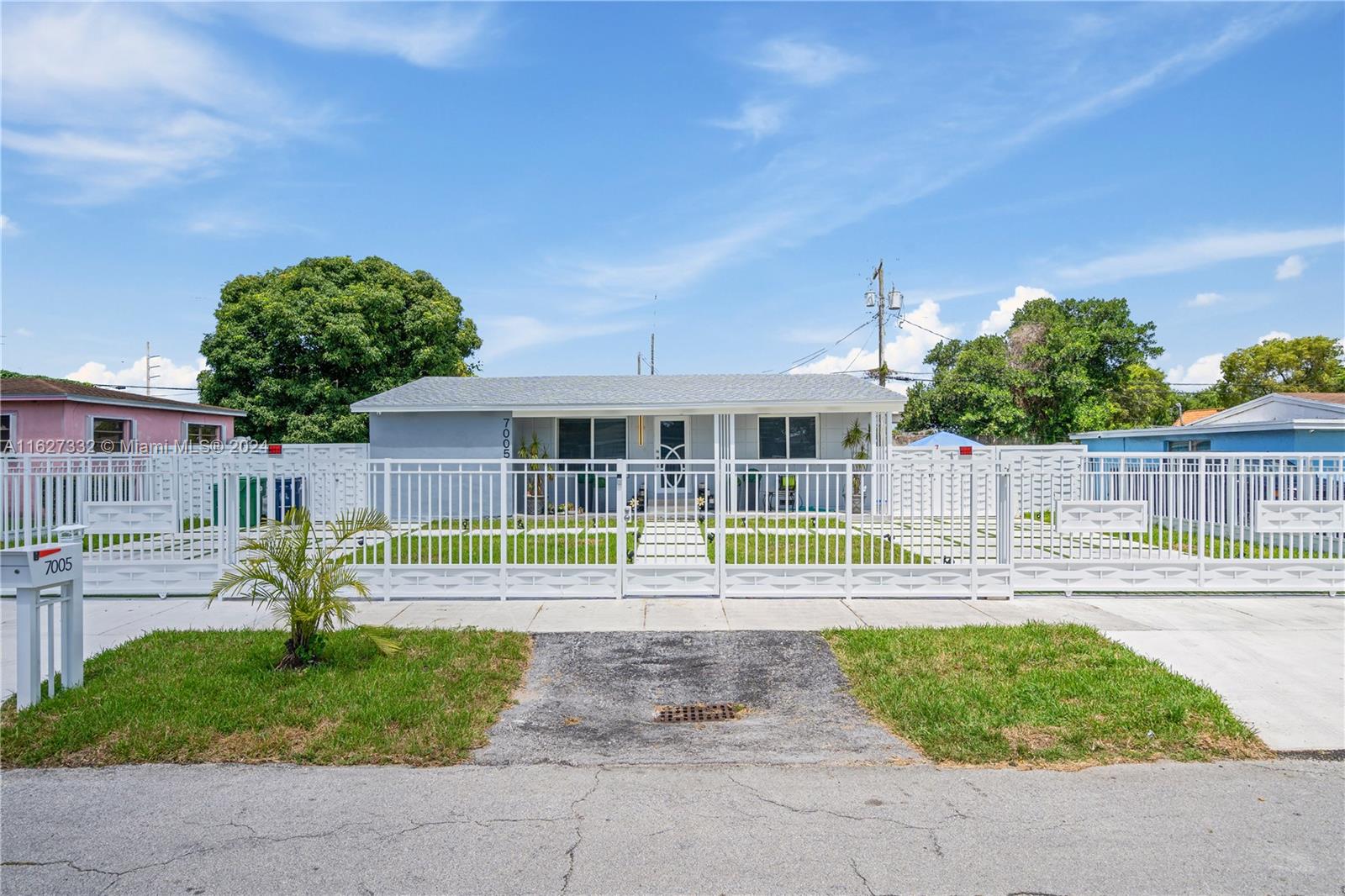 a view of a house with a backyard and a yard