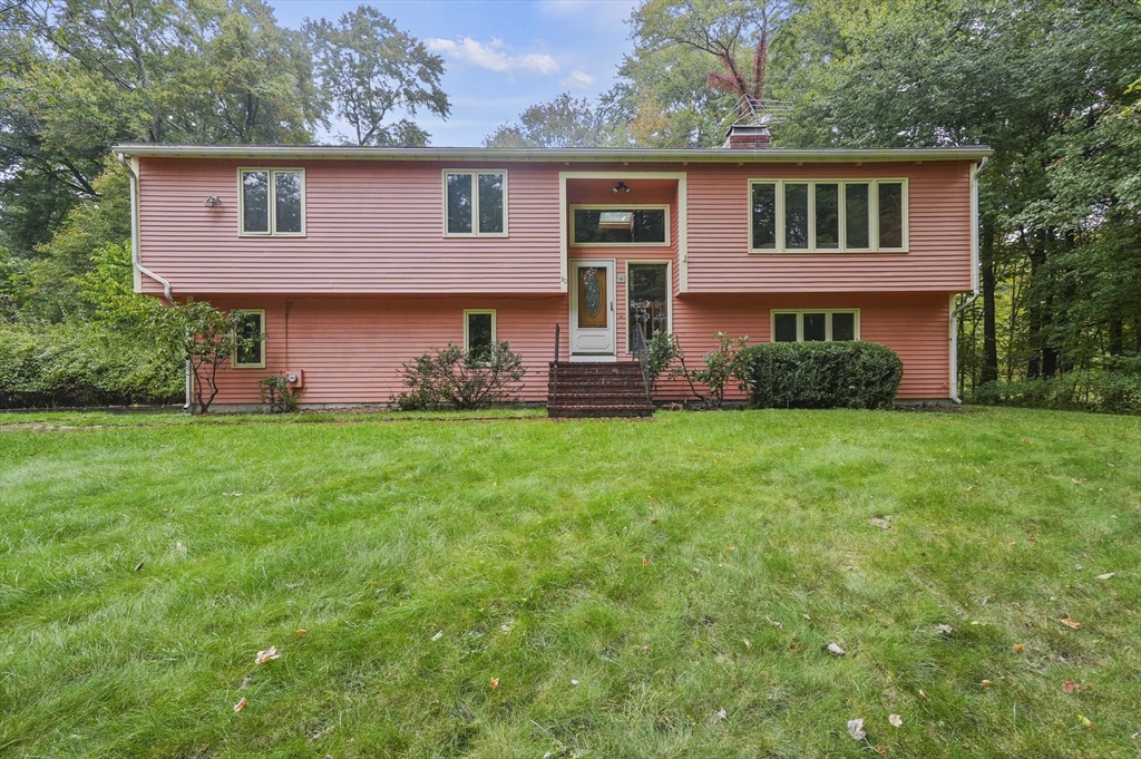 a front view of a house with a garden and yard