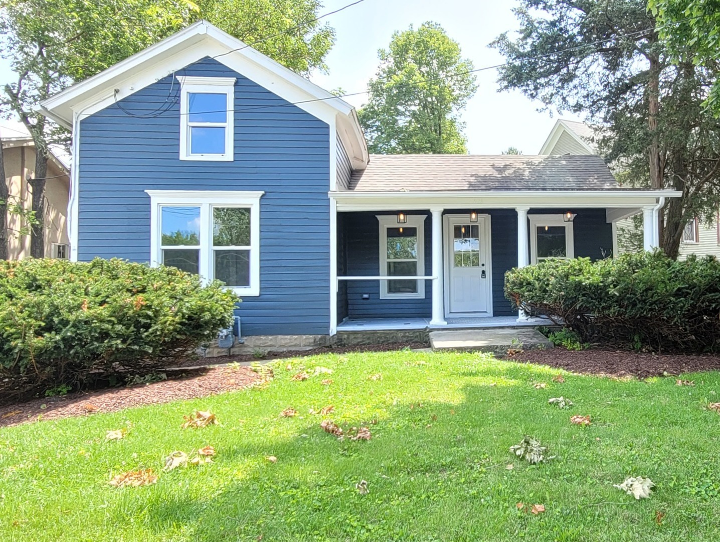 a view of a house with a yard and plants