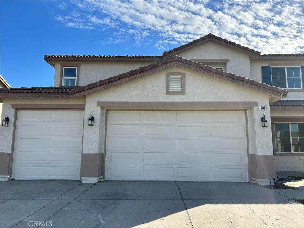 a front view of a house with garage