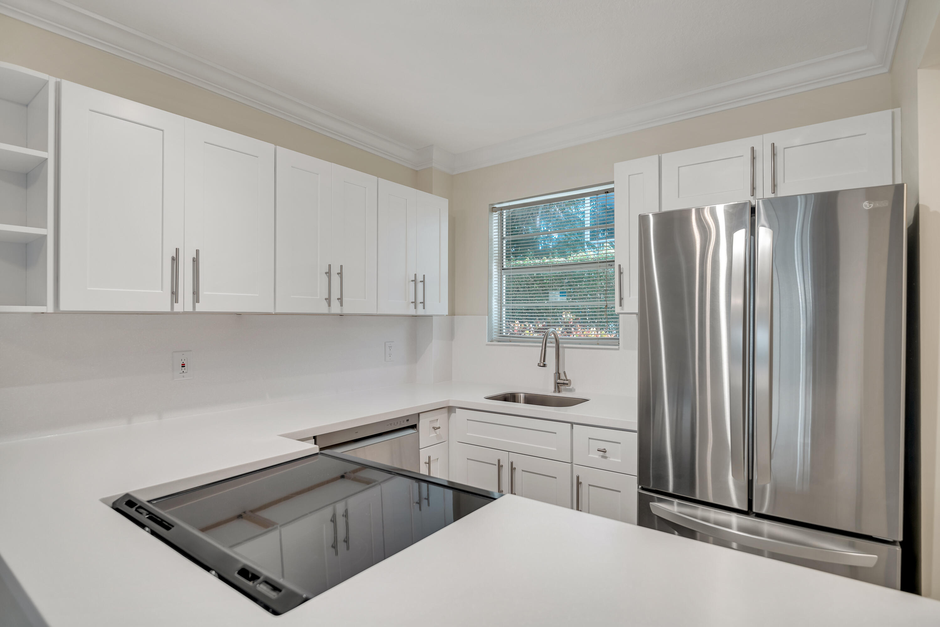 a kitchen with stainless steel appliances a refrigerator sink and cabinets