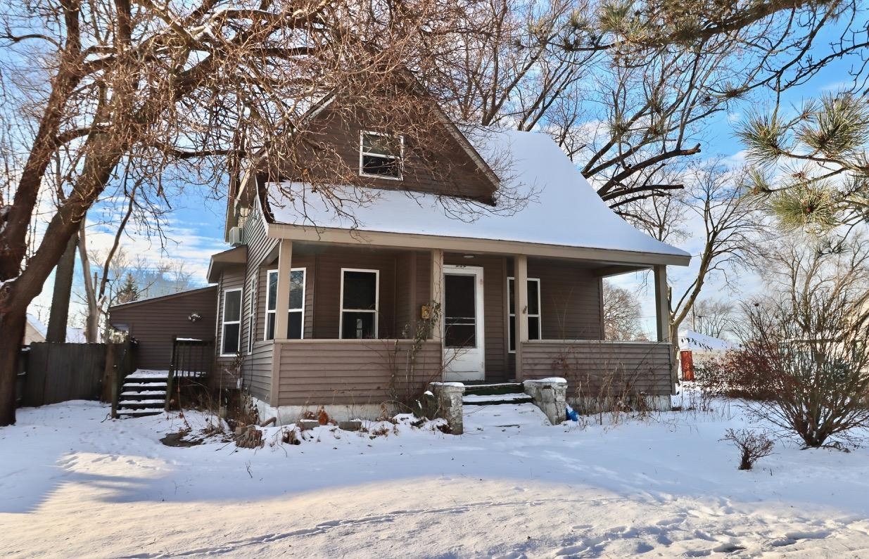 a front view of a house with yard outdoor seating and barbeque oven