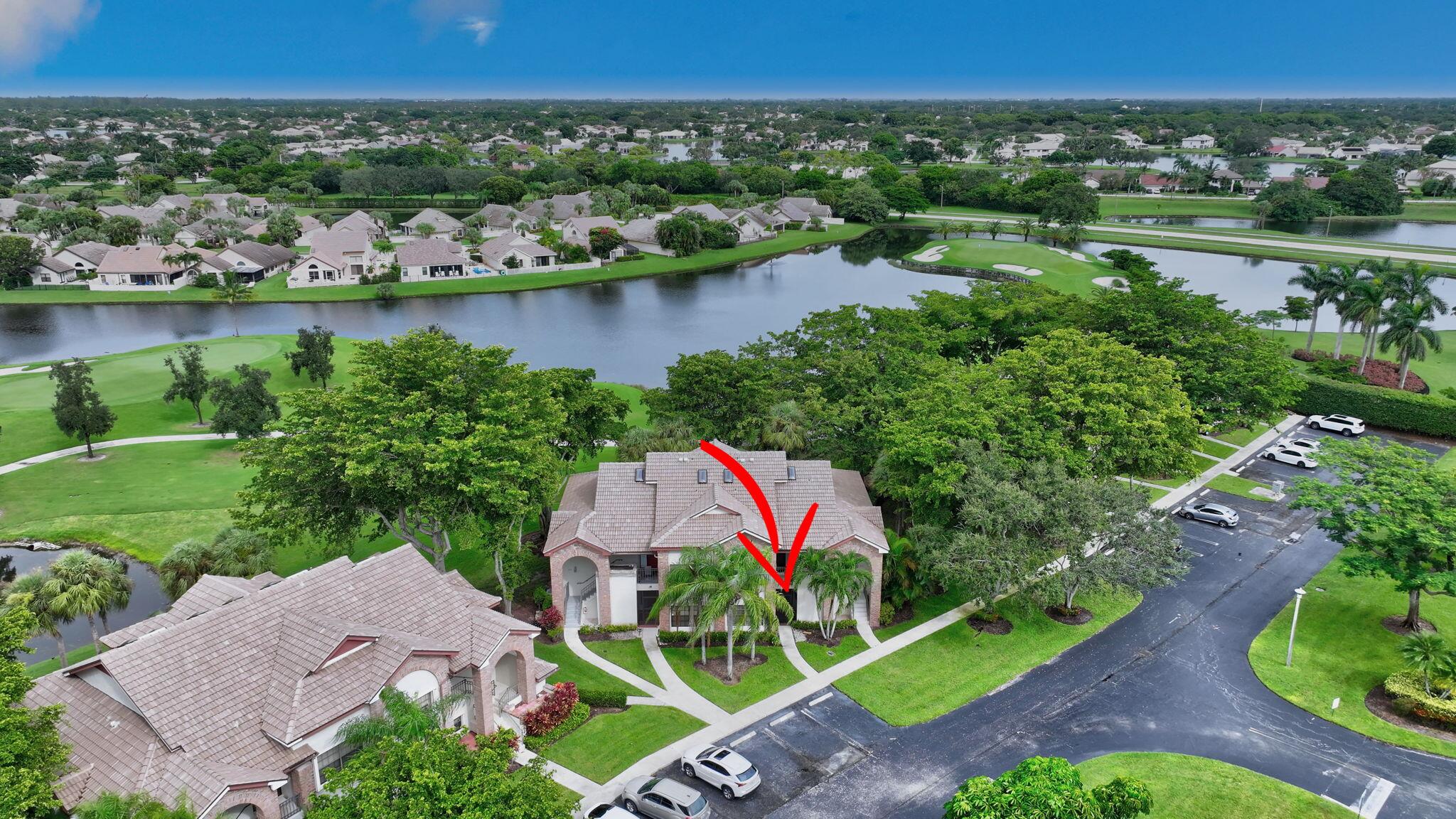 an aerial view of a house with a garden and lake view