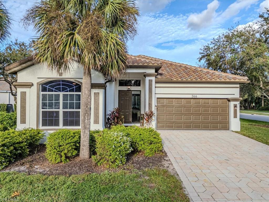 Mediterranean / spanish home featuring a garage