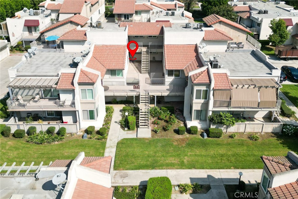 an aerial view of residential houses with outdoor space and street view