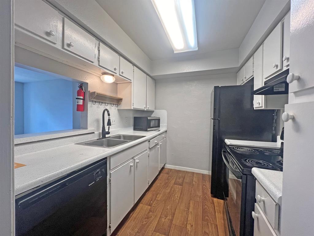 a kitchen with a sink stove and refrigerator