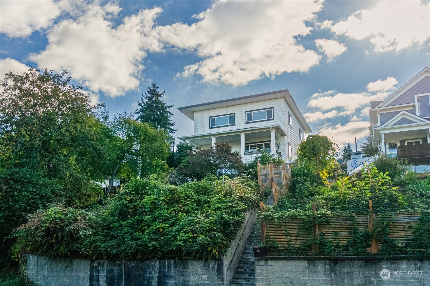 a front view of a house with a garden