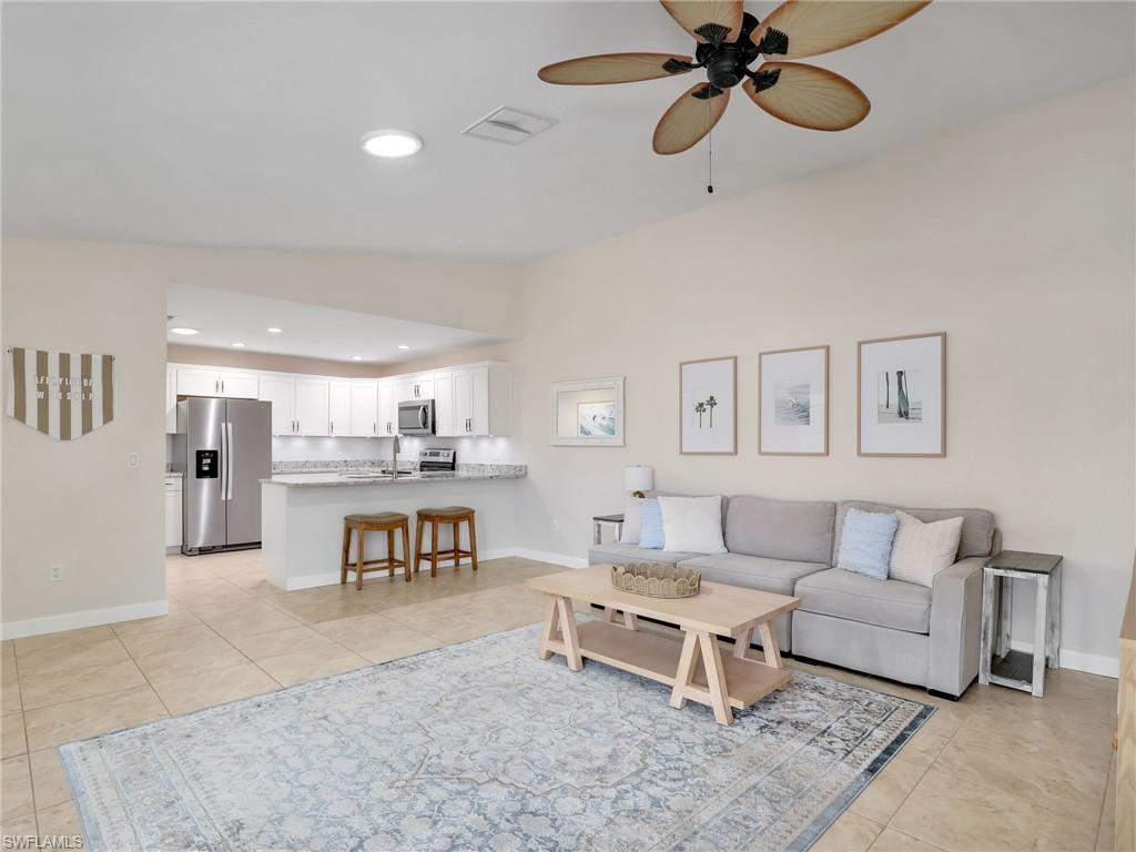 a living room with furniture and a ceiling fan