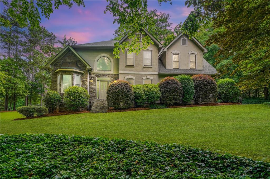 a front view of a house with a garden