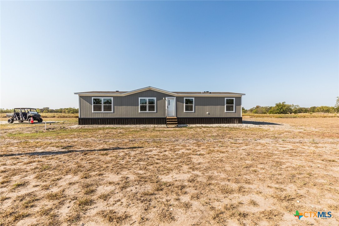 a view of house with yard and ocean view