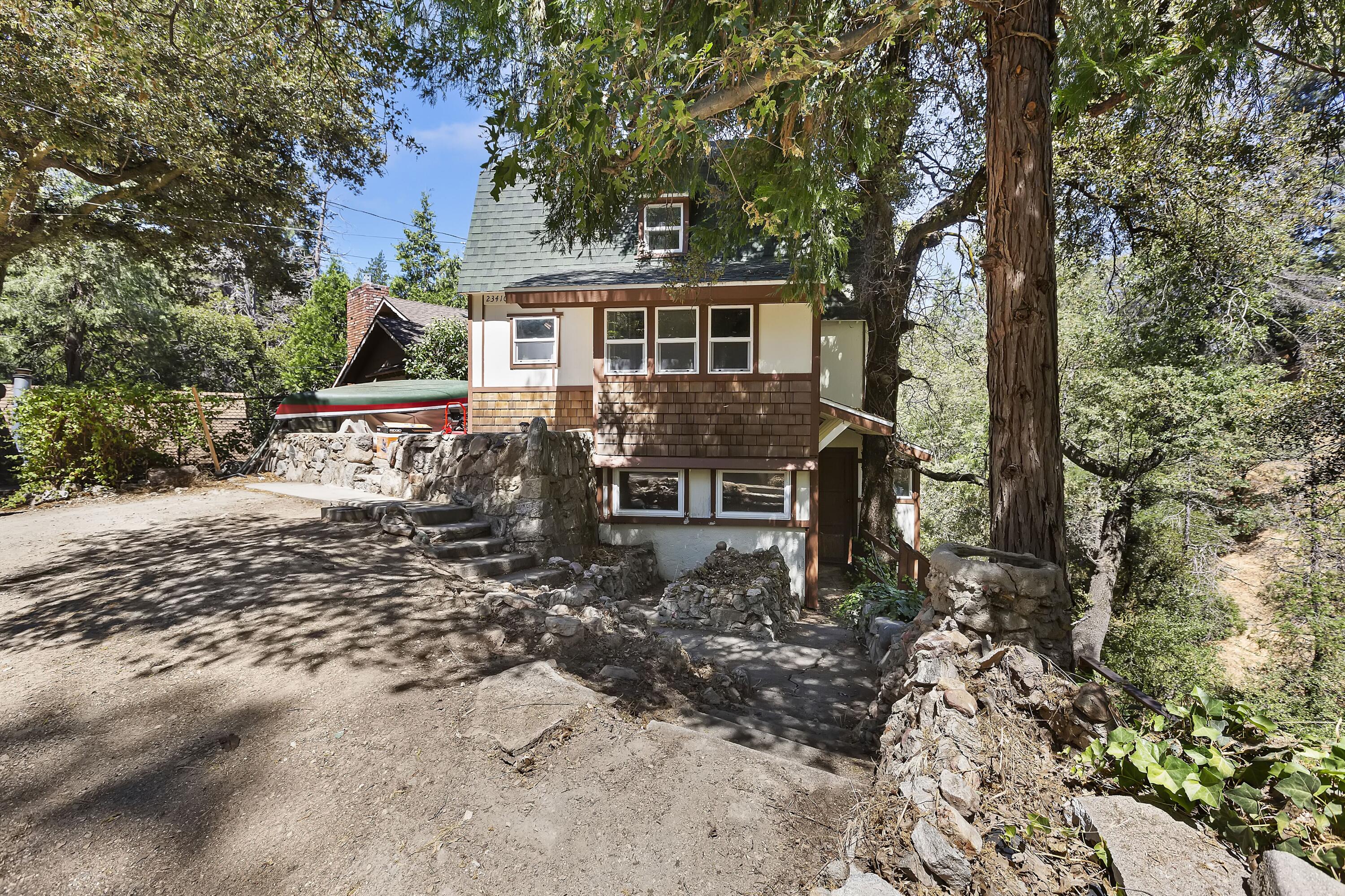 a front view of a house with yard porch and sitting area