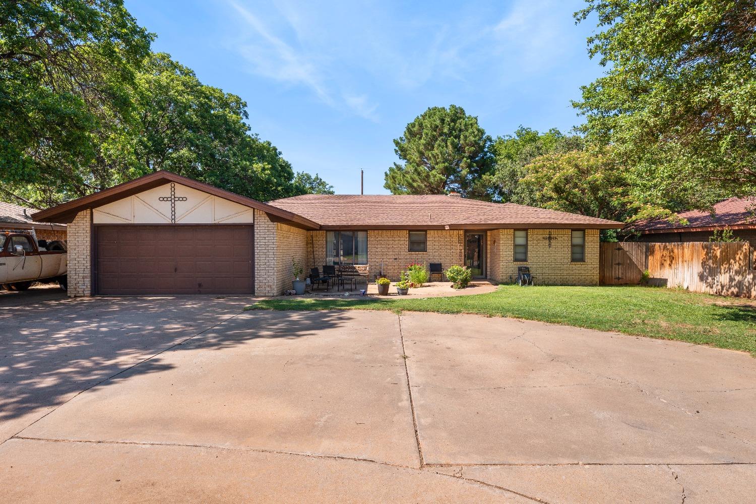 a front view of a house with a yard and a garage