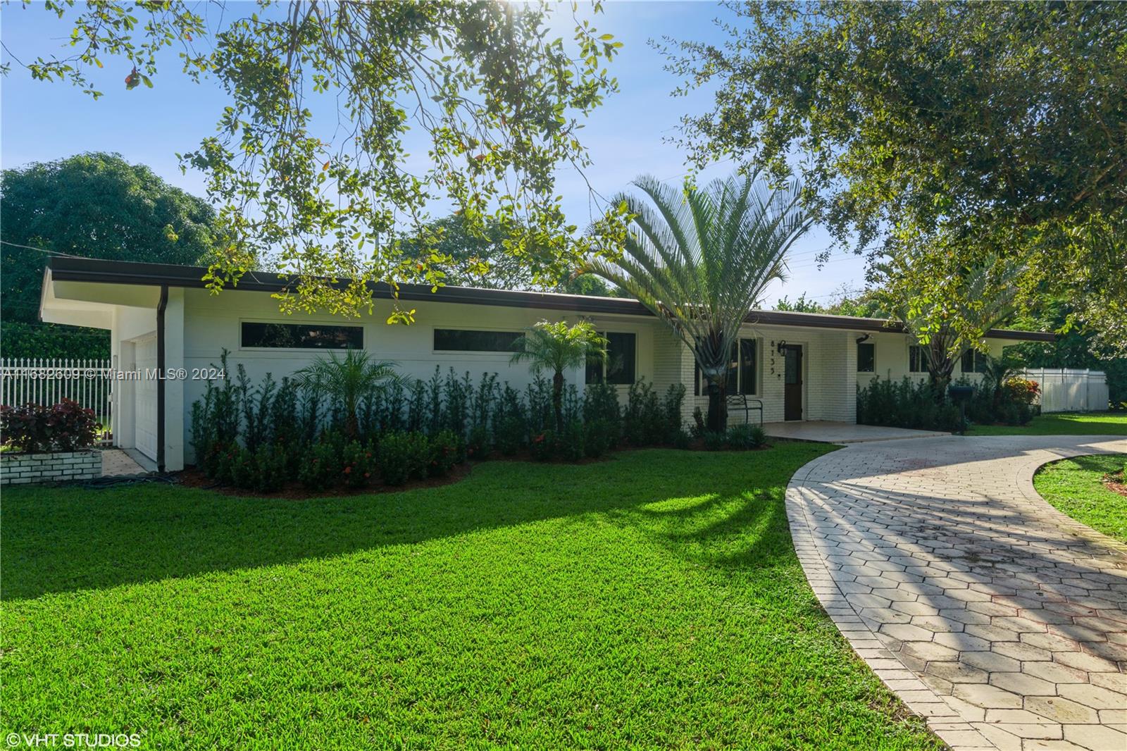 a view of a house with a yard and a garden