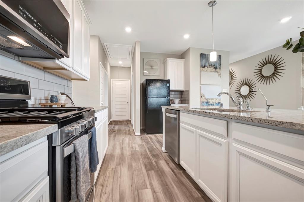 a kitchen with a sink stainless steel appliances and cabinets