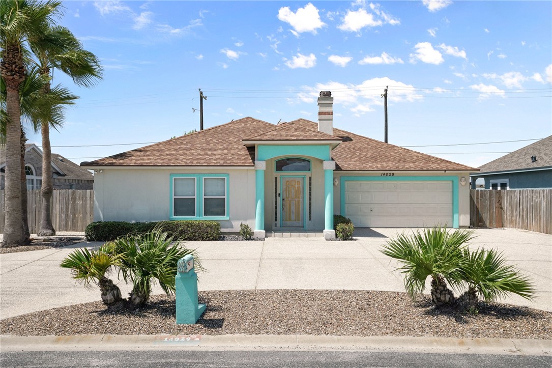 a front view of a house with a yard outdoor seating and garage