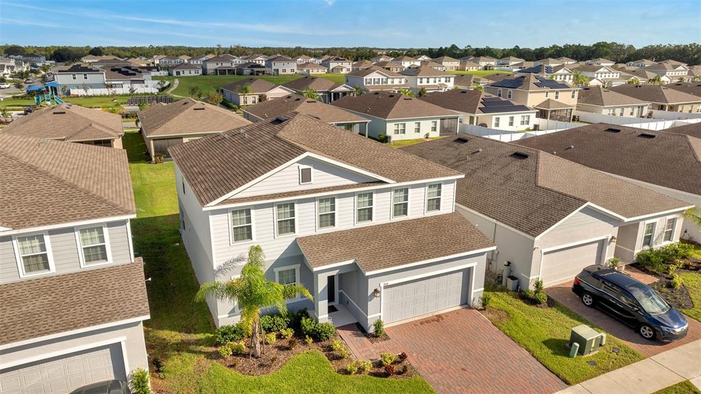 an aerial view of residential houses with outdoor space