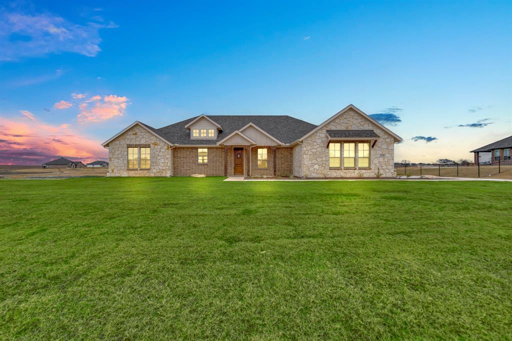 a front view of a house with a yard