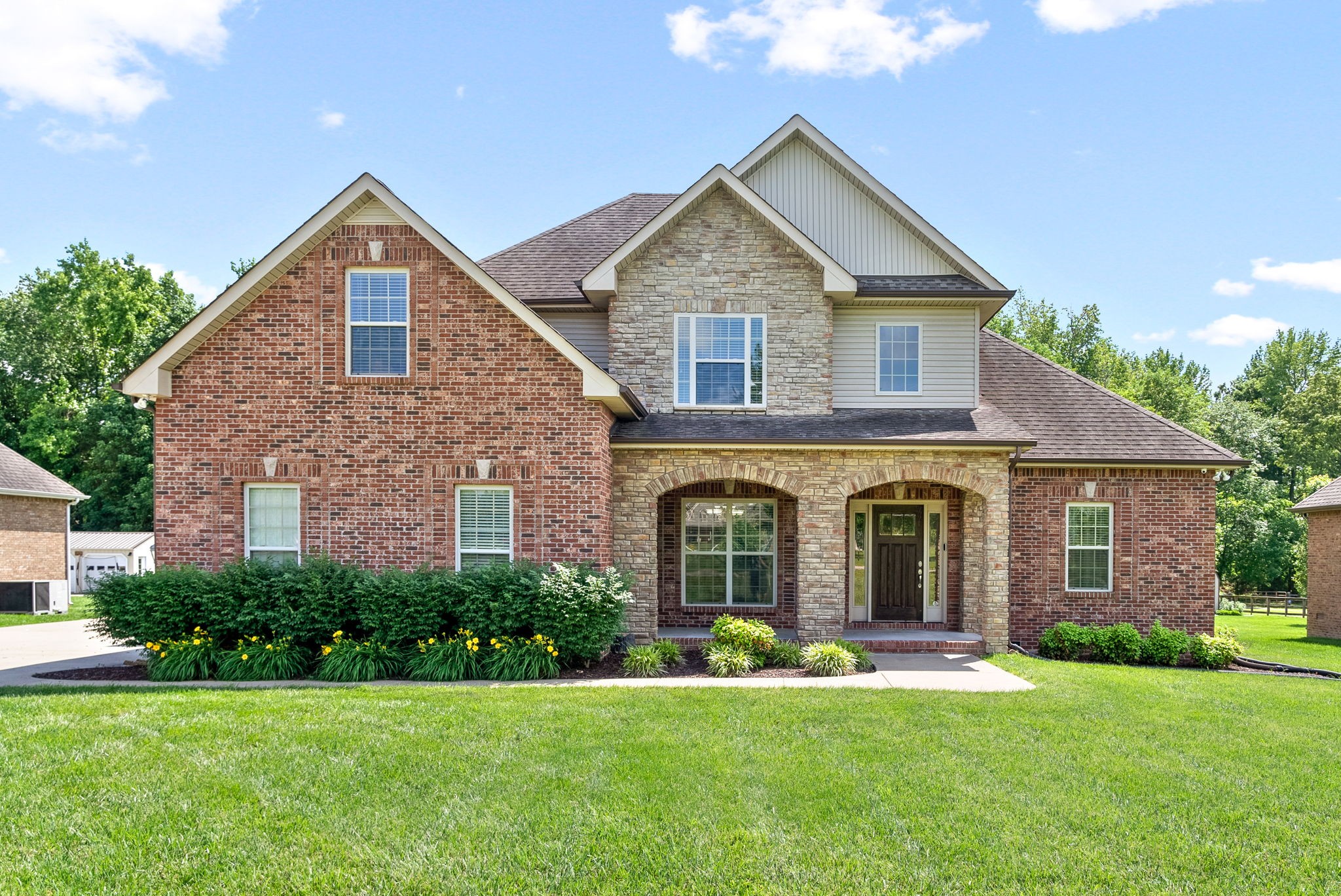 a front view of a house with a yard and garage