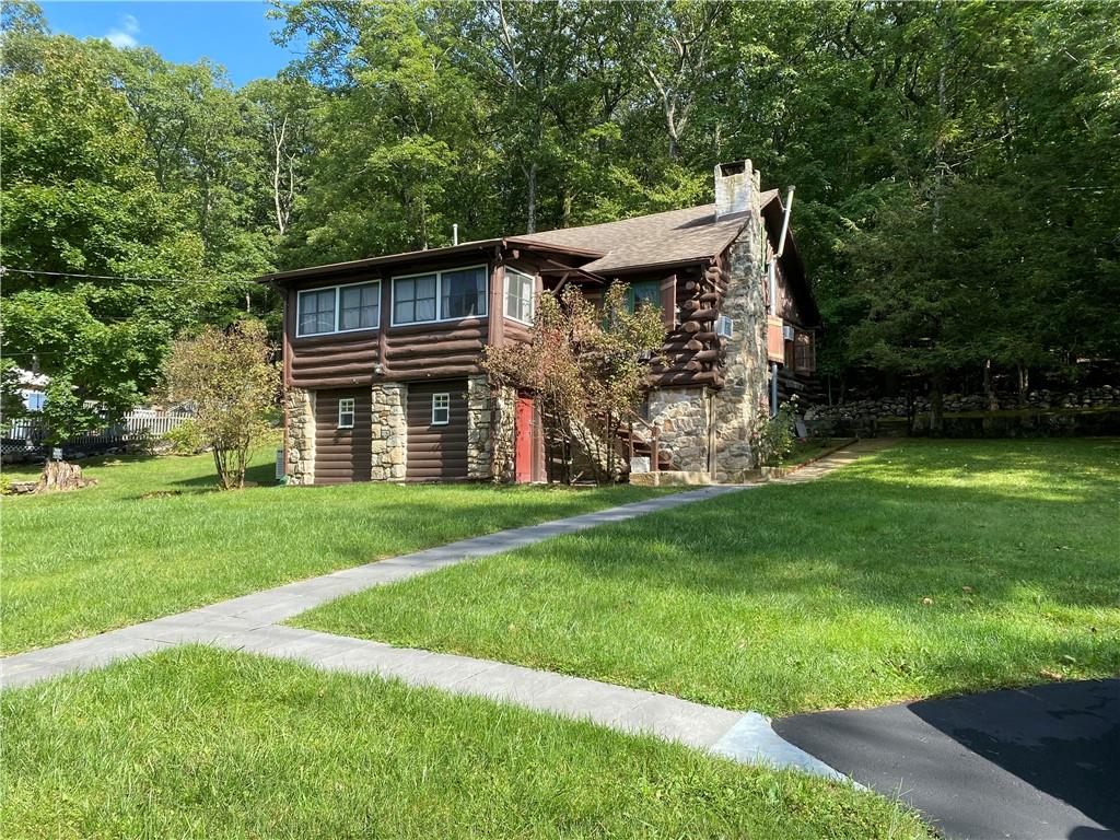 Log cabin with a front lawn