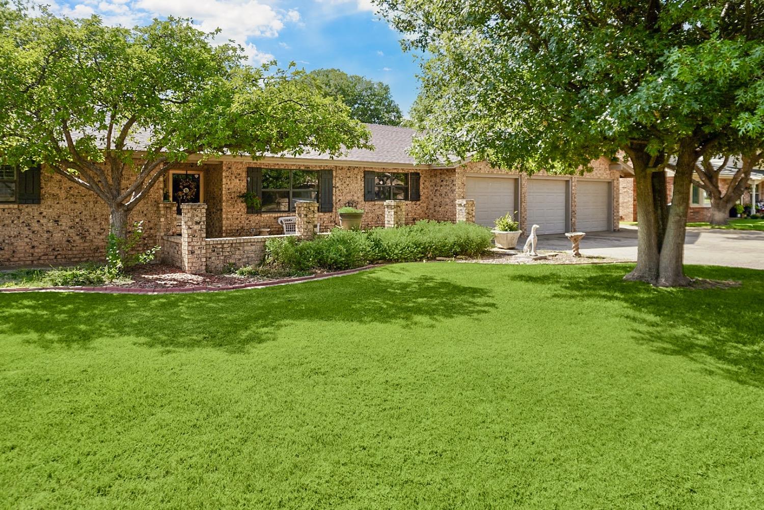 a front view of house with yard and green space