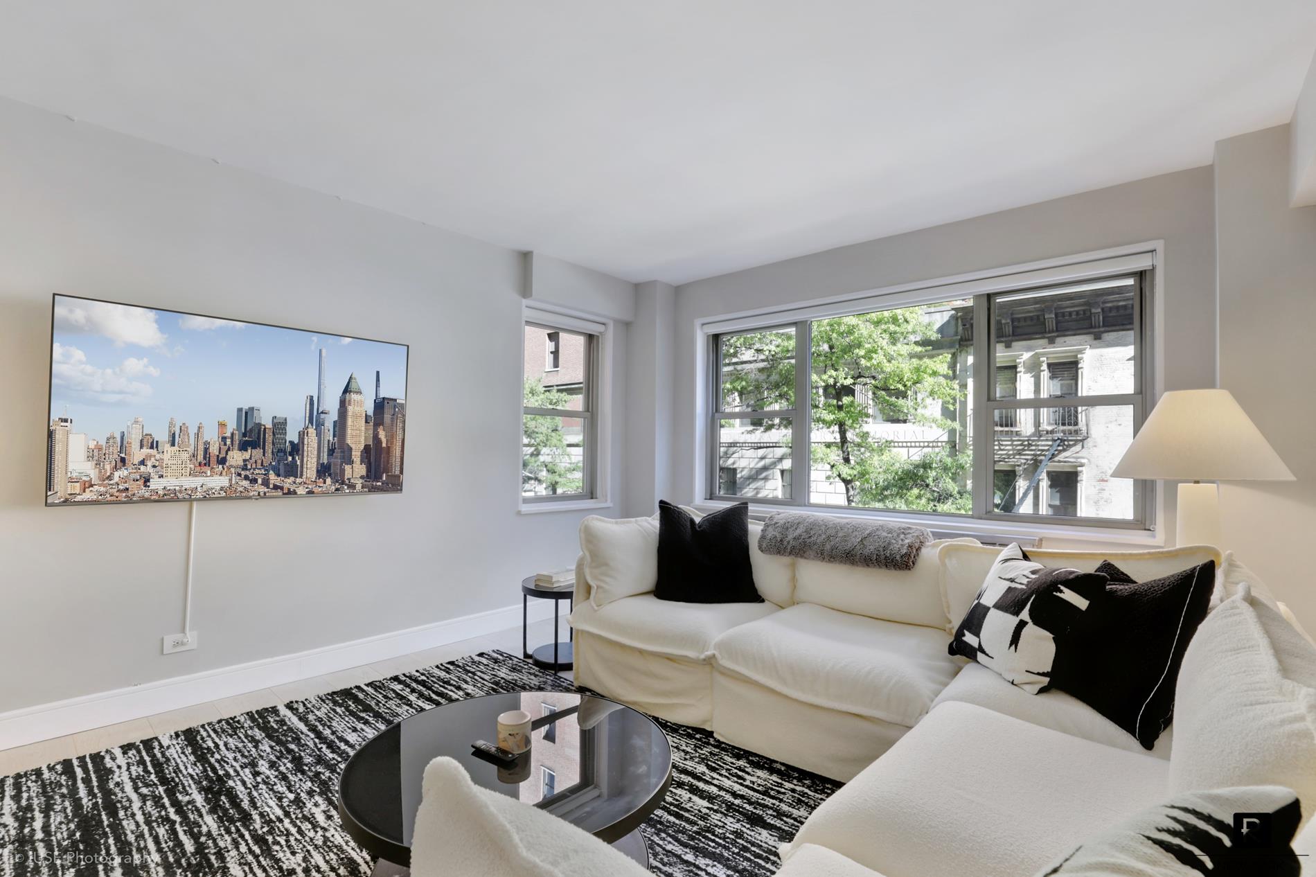 a living room with furniture and a large window