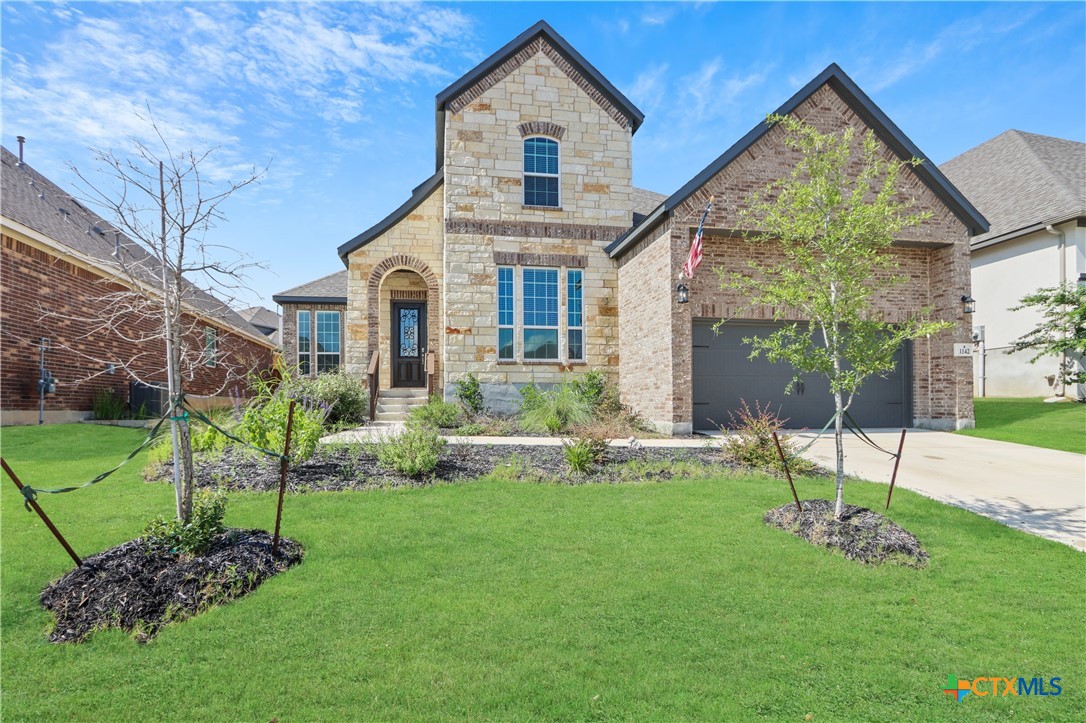 a front view of a house with a yard