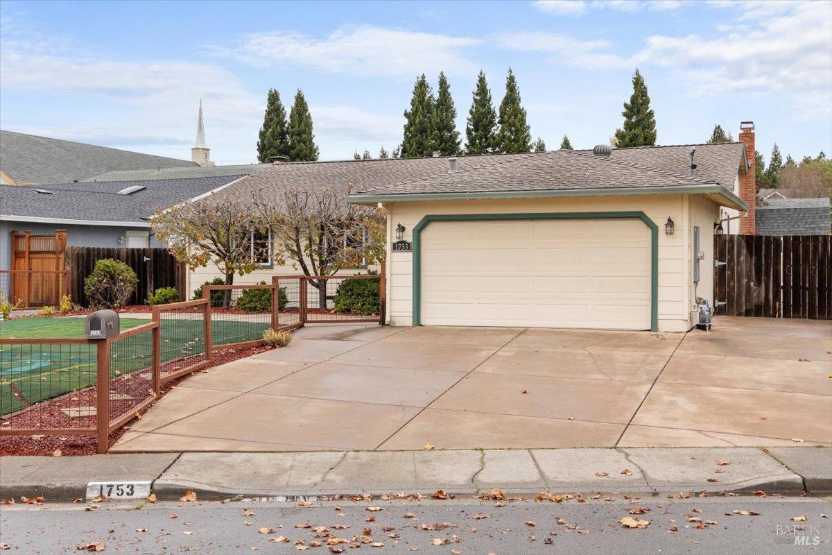 1753 Pine Ave - oversized driveway and spacious front yard with perimeter fencing.