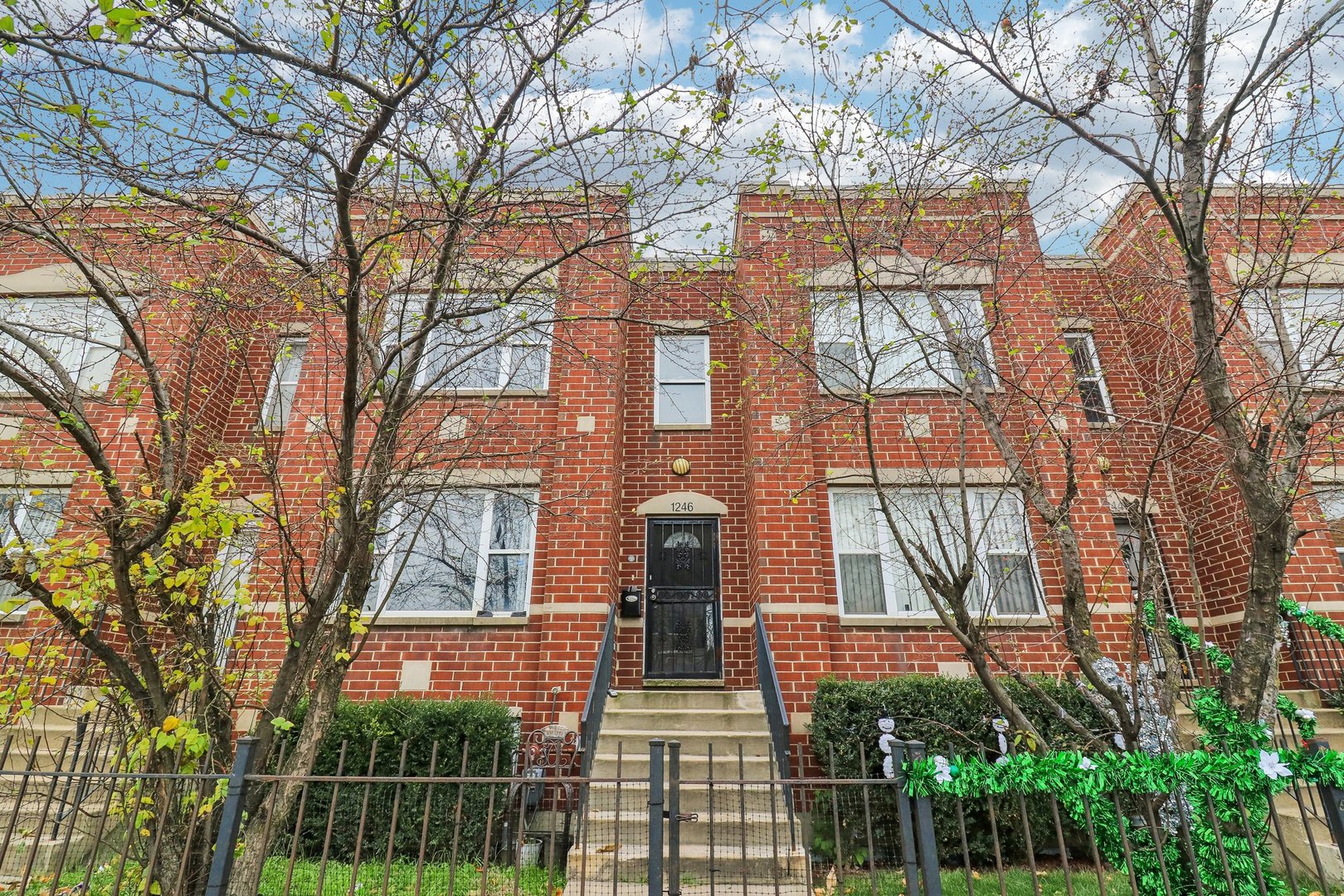 front view of a brick house with large windows